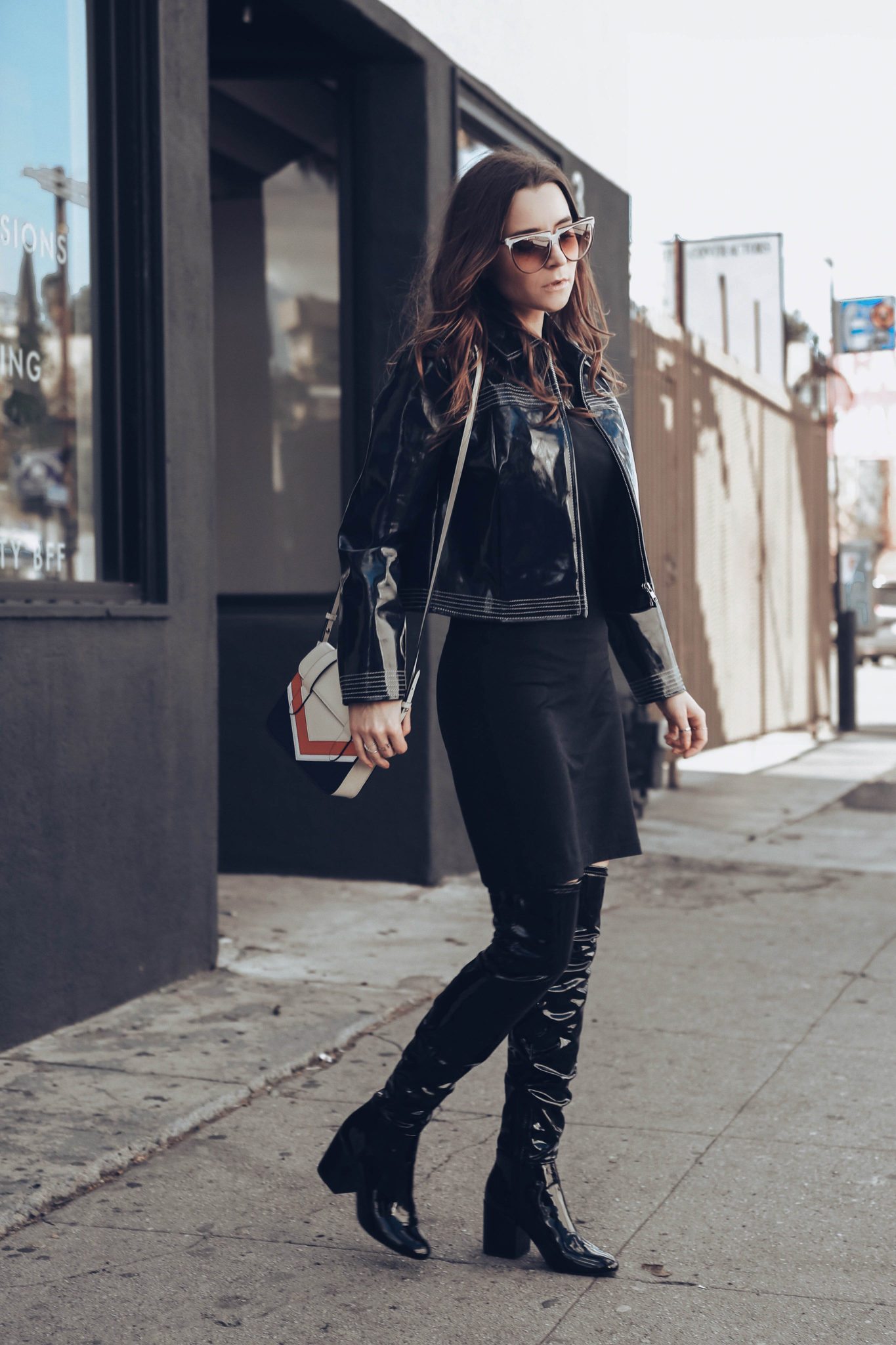 How to style Patent leather jacket and Patent leather boots - How to style the Vinyl trend. More on Houseofcomil.com - Blue Leather jacket by Ganni on If Chic, Nano MC Chevron Bag by Strathberry, Patent Leather Boots OTK by Aldo. Styled by Julia Comil French Fashion Blogger in Los Angeles 