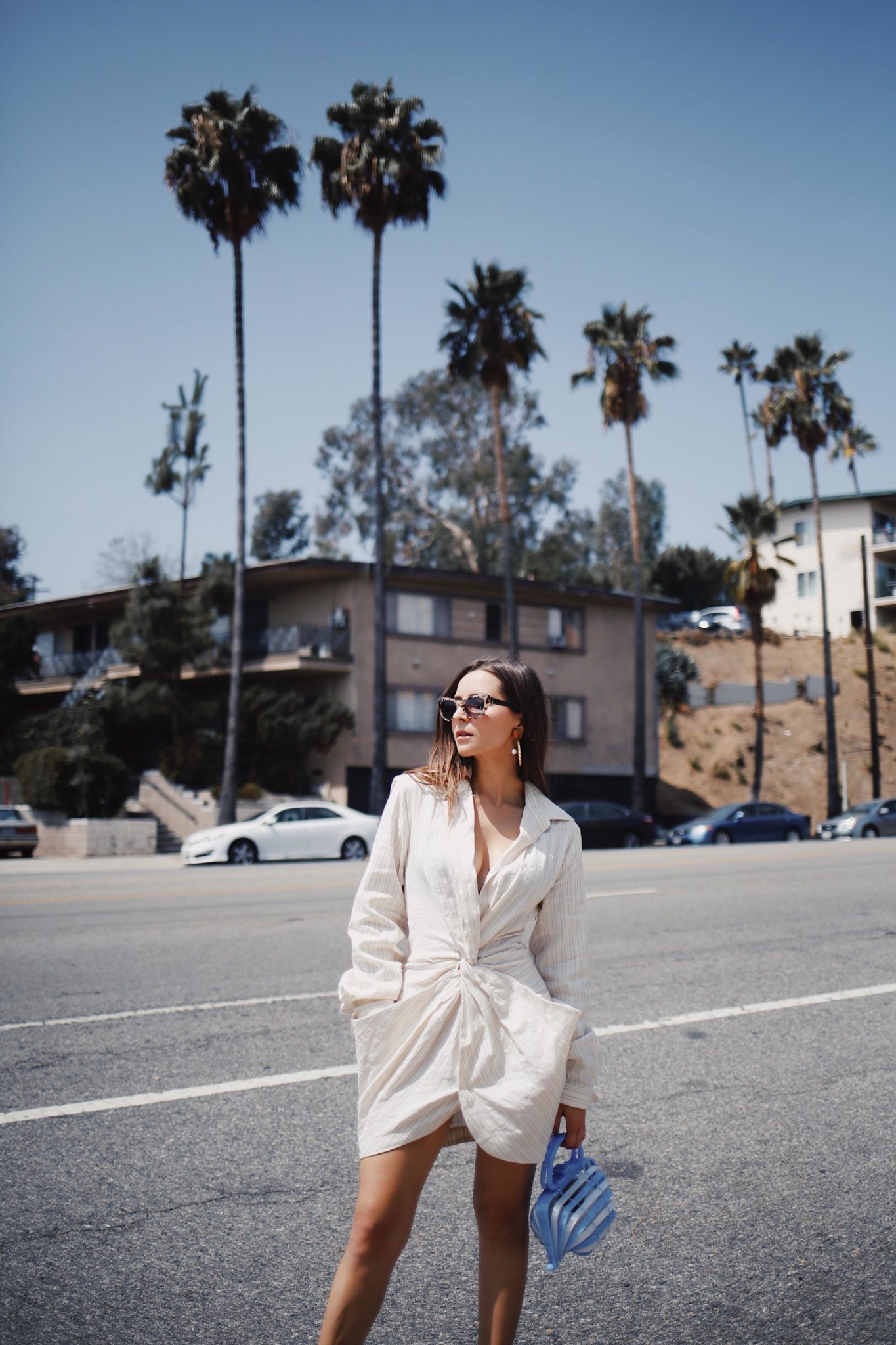 Discover Jacquemus the French Not So Parisian Designer on Houseofcomil.com. French Fashion Blogger Julia Comil is wearing a Jacquemus Dress, Bag Cult Gaia, and Krewe x Reformation sunglasses in Los Angeles