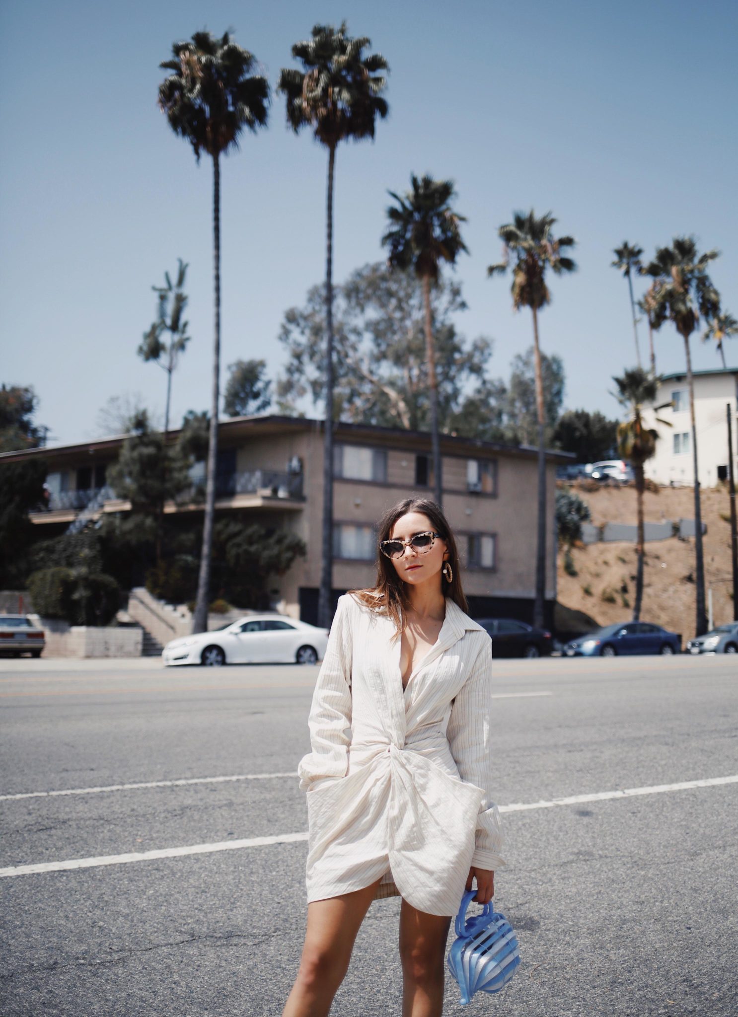 Discover Jacquemus the French Not So Parisian Designer on Houseofcomil.com. French Fashion Blogger Julia Comil is wearing a Jacquemus Dress, Bag Cult Gaia, and Krewe x Reformation sunglasses in Los Angeles