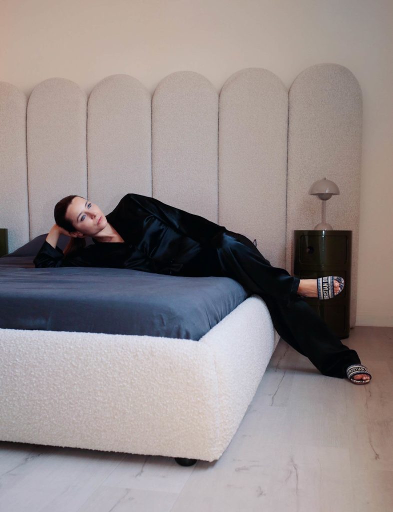Julia Comil french influencer wearing La Perla set, Dior Slides. Sharing French interior decor tips on Modersvp.com. Luxury linen bedding sets and a bed for a refined and understated luxury bedroom.